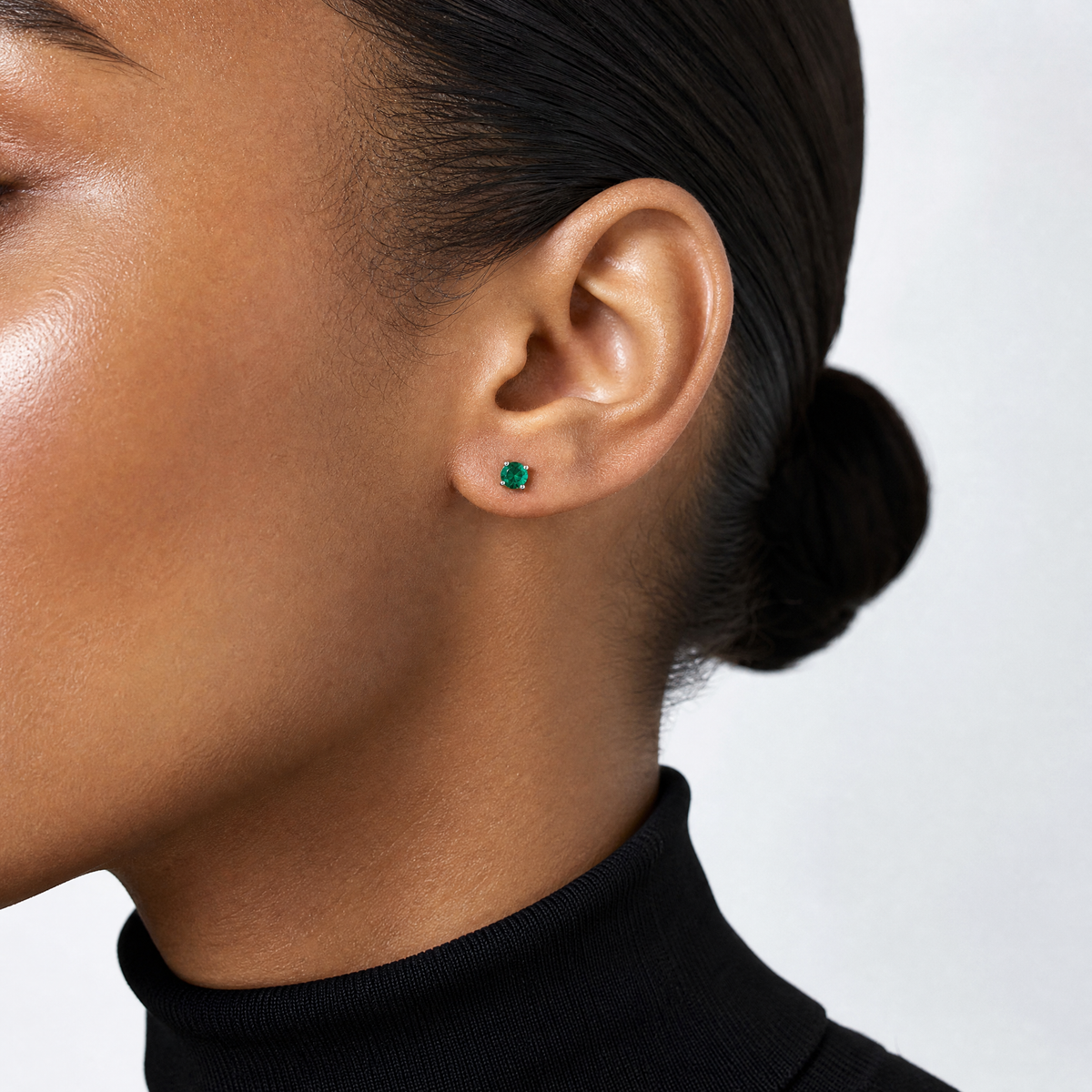 Sterling Silver Rhodium-plated 4mm Round Created Emerald Post Earrings - Model Shot