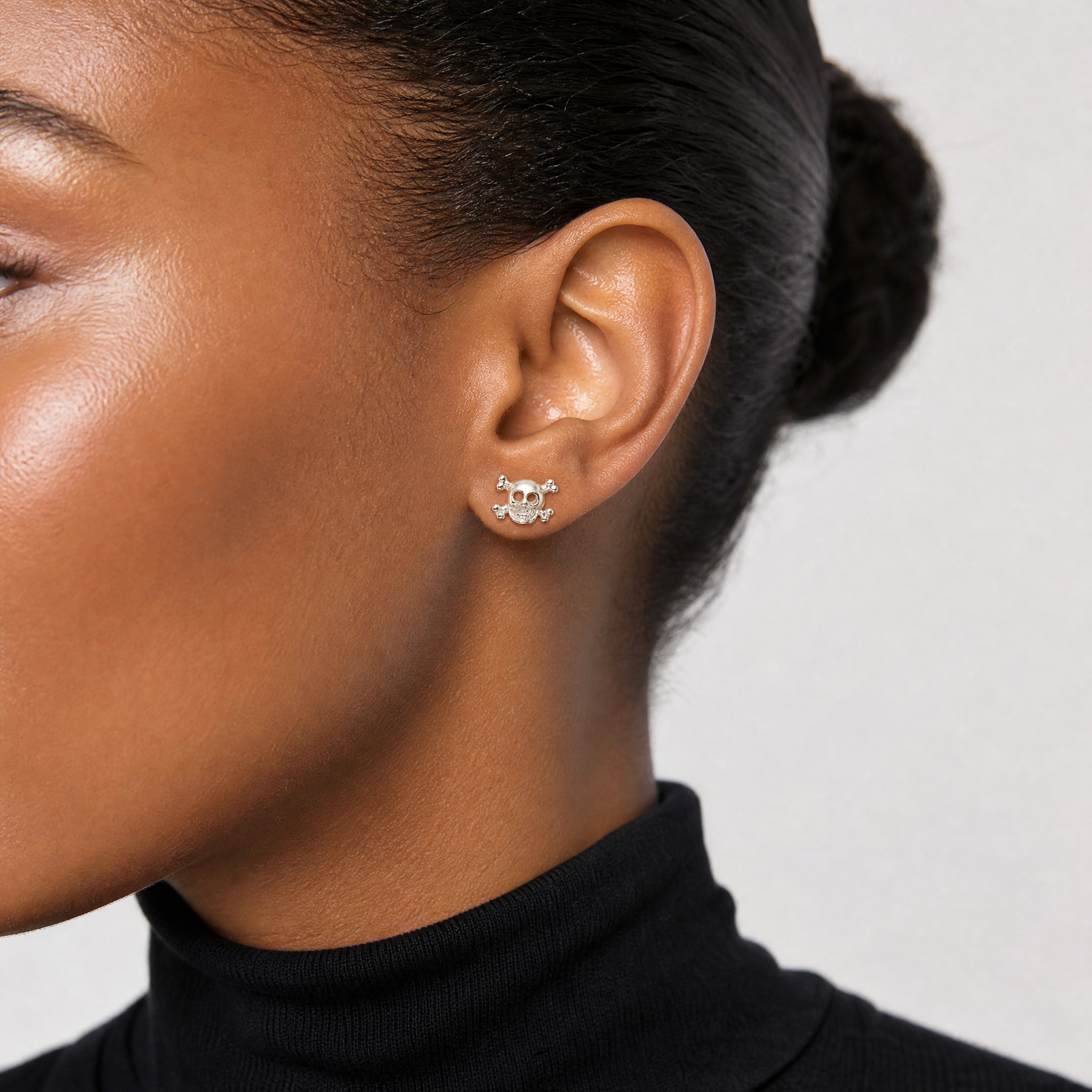 Sterling Silver Polished Skull and Crossbones Post Earrings - Model Shot