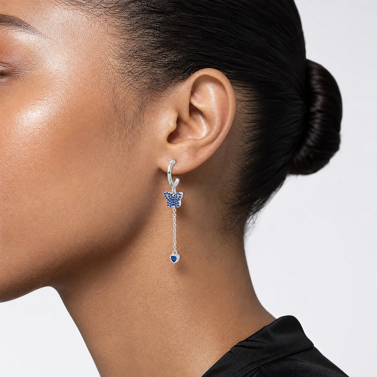 True Fire Sterling Silver Rhod-plated Blue CZ Butterfly Heart Post Hoop Ear - Model Shot