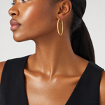 14k Polished 2x50mm  Lightweight Tube Hoop Earrings - Model Shot