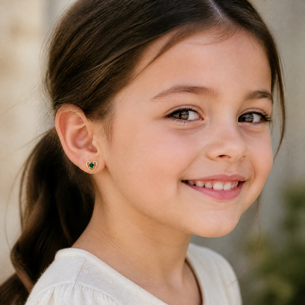 14k Madi K 3mm Created Emerald Birthstone Heart Earrings - Model Shot