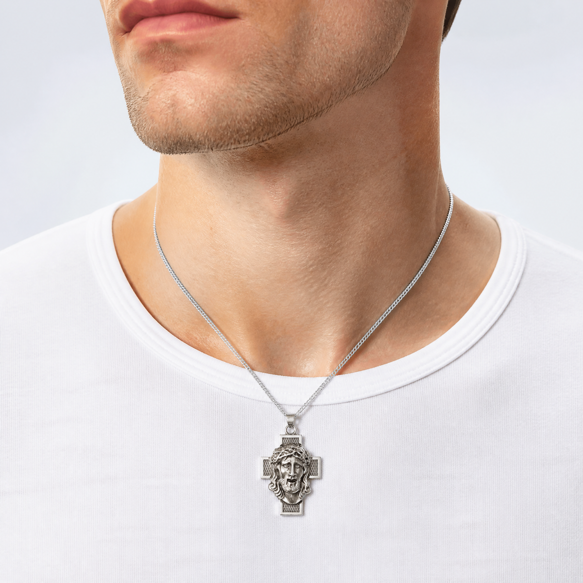Sterling Silver Hollow Satin Antiqued Jesus Cross Medal - Model Shot
