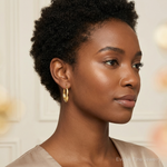 SS Gold-tone Polished Knife Edge Tapered Oval Hoop Earrings - Model Shot